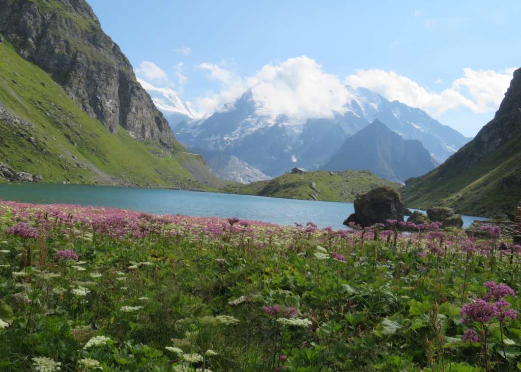 Cabane de Louvie sitting on a small hill next to the Lac de Louvie