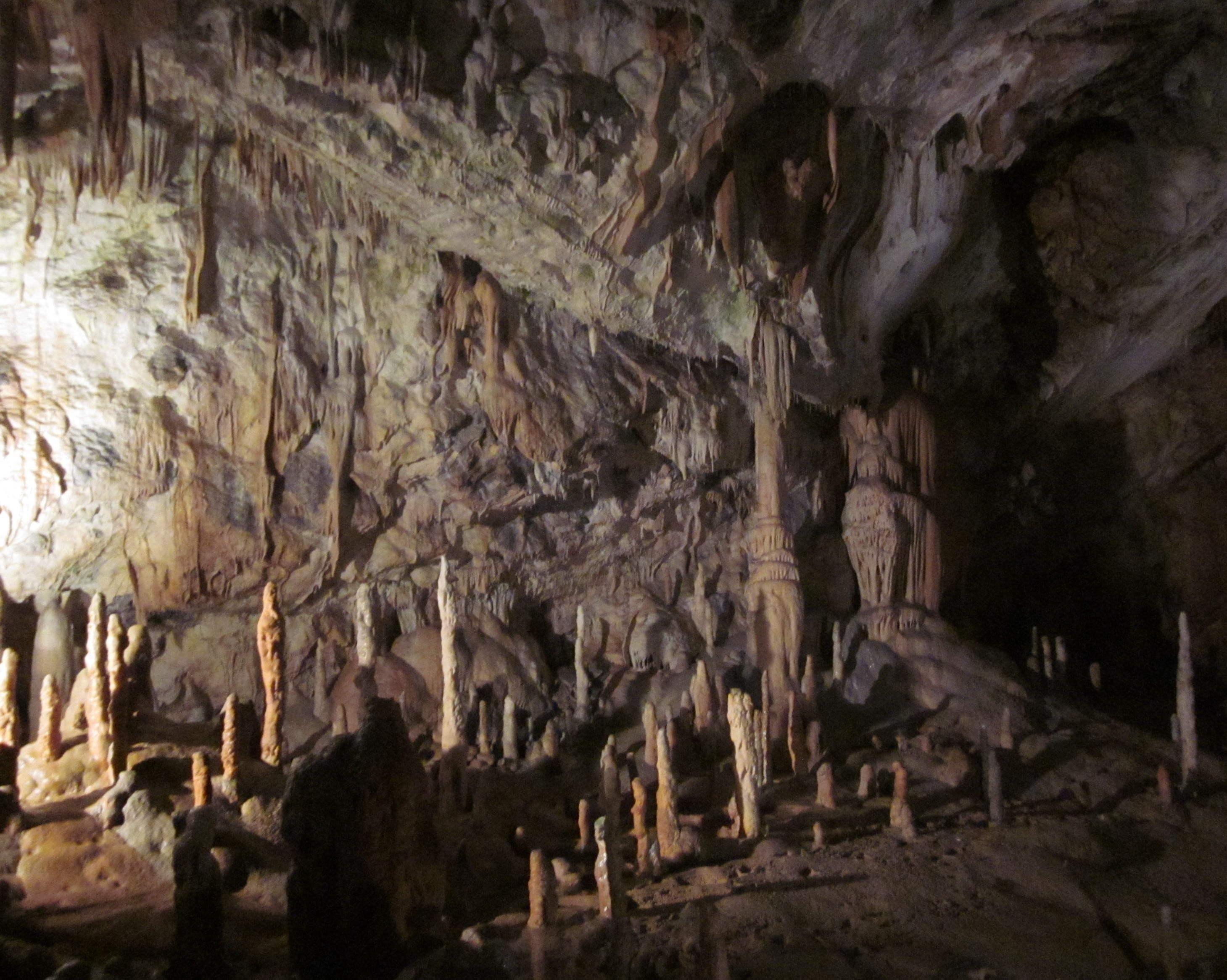 Stalactites hanging from the ceiling and stalagmites rising from the floor